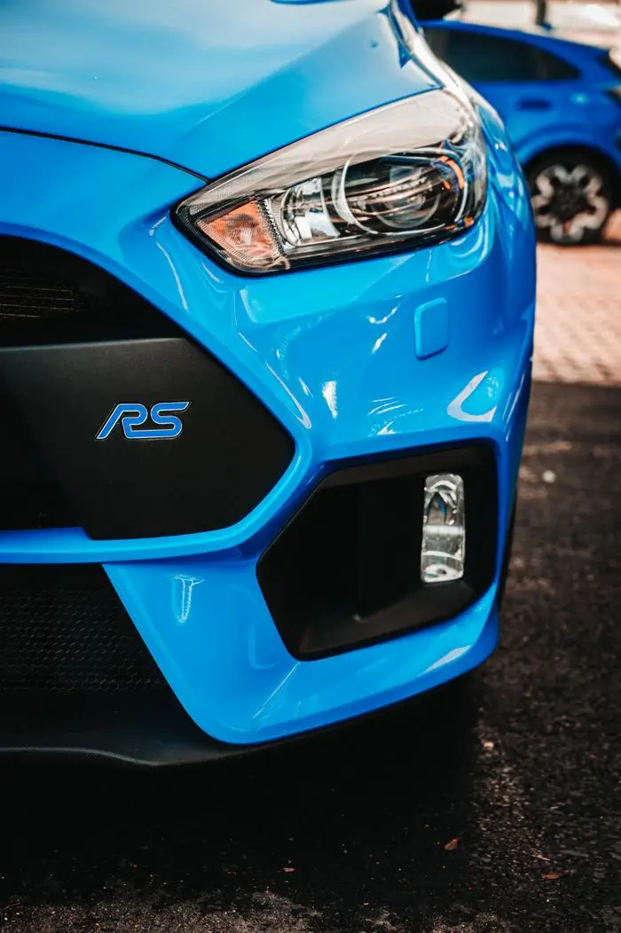 Detailed shot of a blue Ford RS showing the headlight and front bumper design.